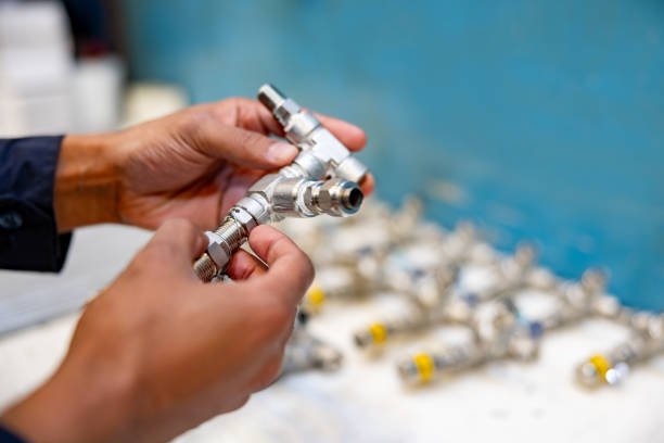 Close-up on a worker making pipeline valves