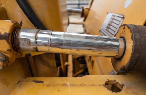 hydraulic cylinder with the oil stain of the small bulldozer on the construction site